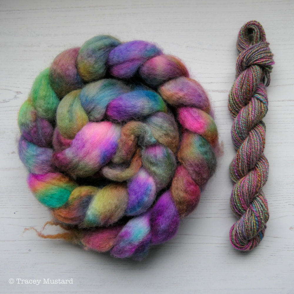 Hand dyed Bluefaced Leicester fibre braid with a sample handspun skein.