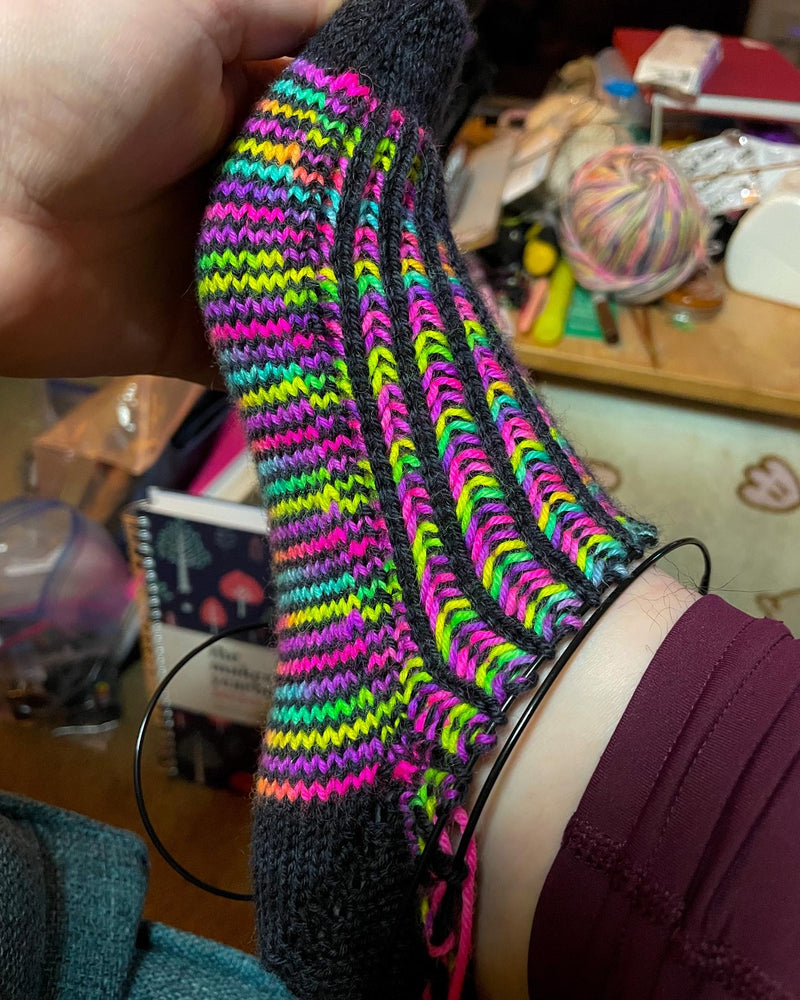 DK Toe Up Brioche Sock in hand dyed neon rainbow and black yarn